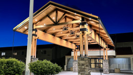 Timber porte-cochère at a hotel entrance in The Dalles, OR, lit with recessed downlights and accent lighting.